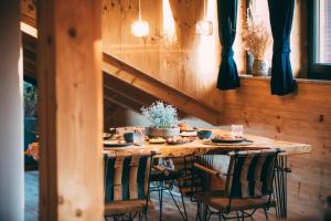 a wooden table with chairs around it with a meal on it at Chalet Alpi in Garmisch-Partenkirchen