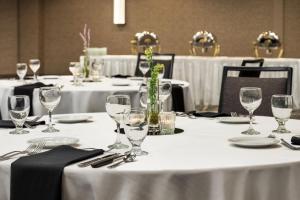 a group of tables with white table cloths and wine glasses at Courtyard by Marriott Columbia in Columbia