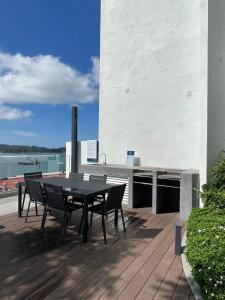 a patio with a table and chairs on a deck at Kota Kinabalu City Centre @ The Shore by Casa Yolo in Kota Kinabalu