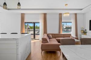a living room with a couch and a table at NEW! Villa Lukas with 44m2 pool in Makarska hinterland in Gornji Vinjani