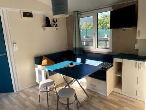 a small kitchen with a blue table and two stools at Ranch Houses in Loučná nad Desnou +7 photos