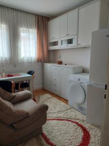 a small kitchen with a table and a refrigerator at Apartman Uki in Vranje
