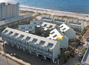 an aerial view of a building next to the beach at Steps to Sand l Ocean views l Smart TVs l Pool in Gulf Shores