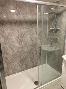 a shower with a glass door in a bathroom at The Earlham Hotel in Norwich