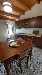 a kitchen with a wooden table in a room at Il Vicoletto in Vittorio Veneto