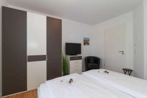 レリクにあるFerienwohnung Ostseebrise Rerikのベッドとテレビのある寝室