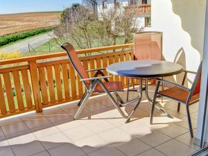 a table and two chairs on a balcony with a view at Ferienwohnung Schneider in Ruhstorf