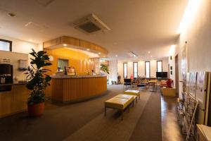 an office lobby with a waiting area and a cafeteria at Business Hotel Ueno in Yamaguchi