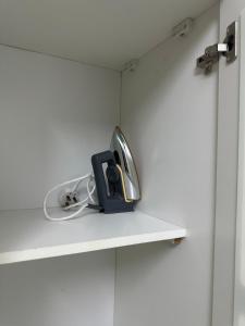 a room with a shelf with a item on it at Al-Olaya Apartment in Umm Lujj