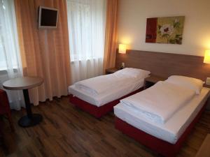 A bed or beds in a room at Hotel Marienthal Garni