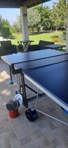 a ping pong table sitting on top of a patio at Secret Garden Residence in Paphos