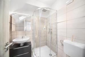 a bathroom with a shower and a sink and a toilet at Ágoston Apartman 1-2 - Lora,Marci in Pécs