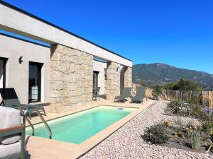 a villa with a swimming pool and a house at Casa di Bà - villa 2 chambres avec piscine à 10 minutes des plages in Afa
