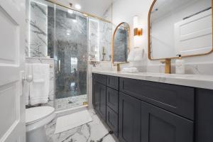 a bathroom with a sink and a shower and a toilet at Luxury Designer Villa by the Beach Bright Beautiful Brand New in Galveston +37 photos