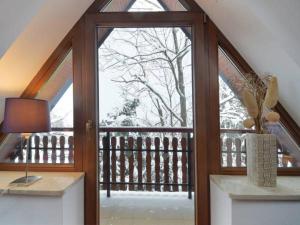 an open door to a balcony with a tree outside at Apartament Pod Giewontem in Zakopane
