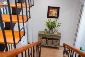 a staircase in a room with a table with a plant at Tranquility Stay Old Quarter in Hanoi +41 photos