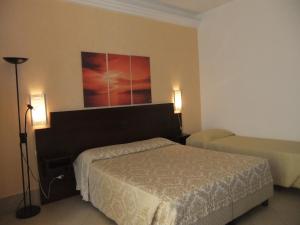 Posteľ alebo postele v izbe v ubytovaní Hotel Villa Ionia