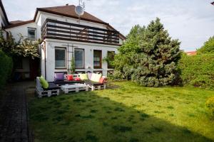 a house with a yard with a couch in the grass at Apartament Miriada 16 in Rowy