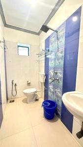 a bathroom with a toilet and a sink at Hotel Baga Bay 200 Meters From Baga Beach in Baga
