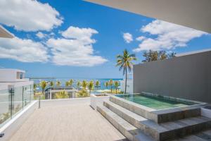 a view of the ocean from a house with a swimming pool at Latitude By Horizon Holidays in Rivière Noire