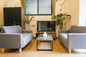 a living room with two couches and a coffee table at Lodging Tokyo Tj03 in Tokyo