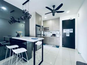 a kitchen with a ceiling fan and a counter with stools at Kama Homestay @Wangsa Maju in Kuala Lumpur