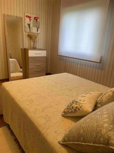 a bedroom with a large bed and a mirror at Casa de campo in Pontevedra