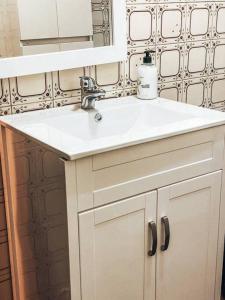 a bathroom with a white sink and a mirror at Casa de campo in Pontevedra +23 photos