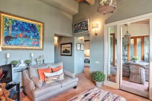a living room with a couch and a painting on the wall at La Loggia in Castelfalfi