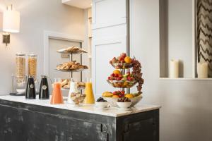 a table with bowls of fruit and other foods on it at Acacias Etoile in Paris