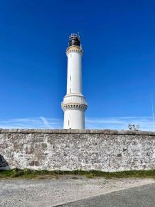 a lighthouse sitting on top of a stone wall at Lighthouse Cottage With Hottub in Aberdeen