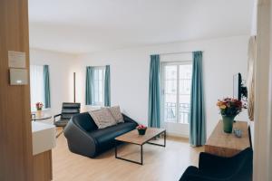 a living room with a couch and a chair at River Residence in Baden +81 photos