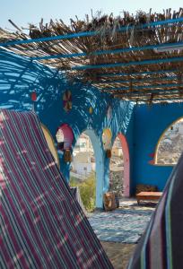 a blue room with arches and a blue wall at Heissa Hostel in Aswan