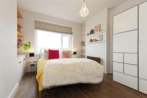 a bedroom with a bed and a window at Walpole Bay Sea Views in Margate