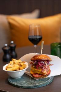a sandwich and a bowl of fries and a glass of wine at Brussels Marriott Hotel Grand Place in Brussels