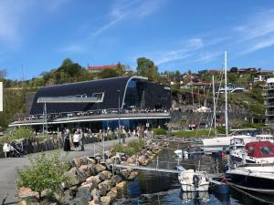 a group of people standing outside of a marina at Villa Henrikke Myhre in Osøyro