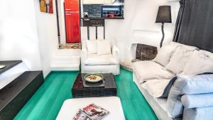 a living room with a couch and a table at Smaris Collection Luxury villas/Cosmopolitan villa,heated pool in Sissi