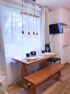 a wooden table with plates on it next to a window at The Blueberry Inn in Rovaniemi +42 photos