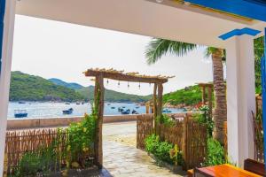 an entrance to a house with a view of the water at La Mer - Vĩnh Hy bay - beachfront villa CHÀI in Vĩnh Hy