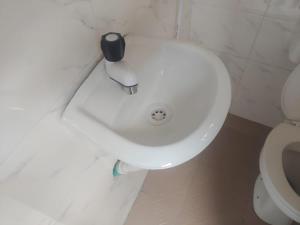 a white sink in a bathroom next to a toilet at Dlulus Ventures Mini Flat apartment sabo in Lagos