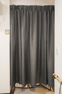a curtain is shown in a room at LodgingToyko Minowa formerly Hostel HIDEAWAY in Tokyo