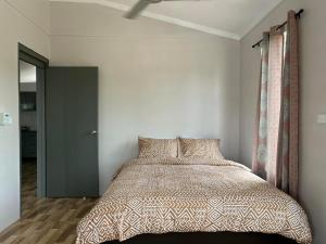 a bedroom with a bed in a room with a ceiling at Samah Apartments in Mba +9 photos