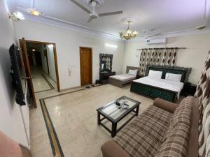 a living room with a couch and a table at Karachi Family Guest House in Karachi