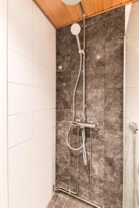 a shower in a bathroom with white tiles at Levitori 3 in Levi +15 photos