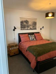 um quarto com uma cama com almofadas vermelhas em PETIT HAVRE DE PAIX em Vergèze