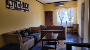 a living room with a couch and a table at Quest in Lilongwe