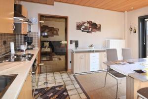 a kitchen with a table and chairs in a room at Schneckenhütte in Meschede