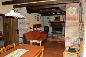a living room with a couch and a fireplace at Granja de Cantarinas in Ciudad-Rodrigo