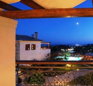 a view from a balcony of a house at night at Iakovakis Suites & Spa in Koropi
