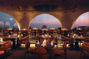 a restaurant with tables and chairs with a view at Centara Mirage Resort Mui Ne in Mui Ne